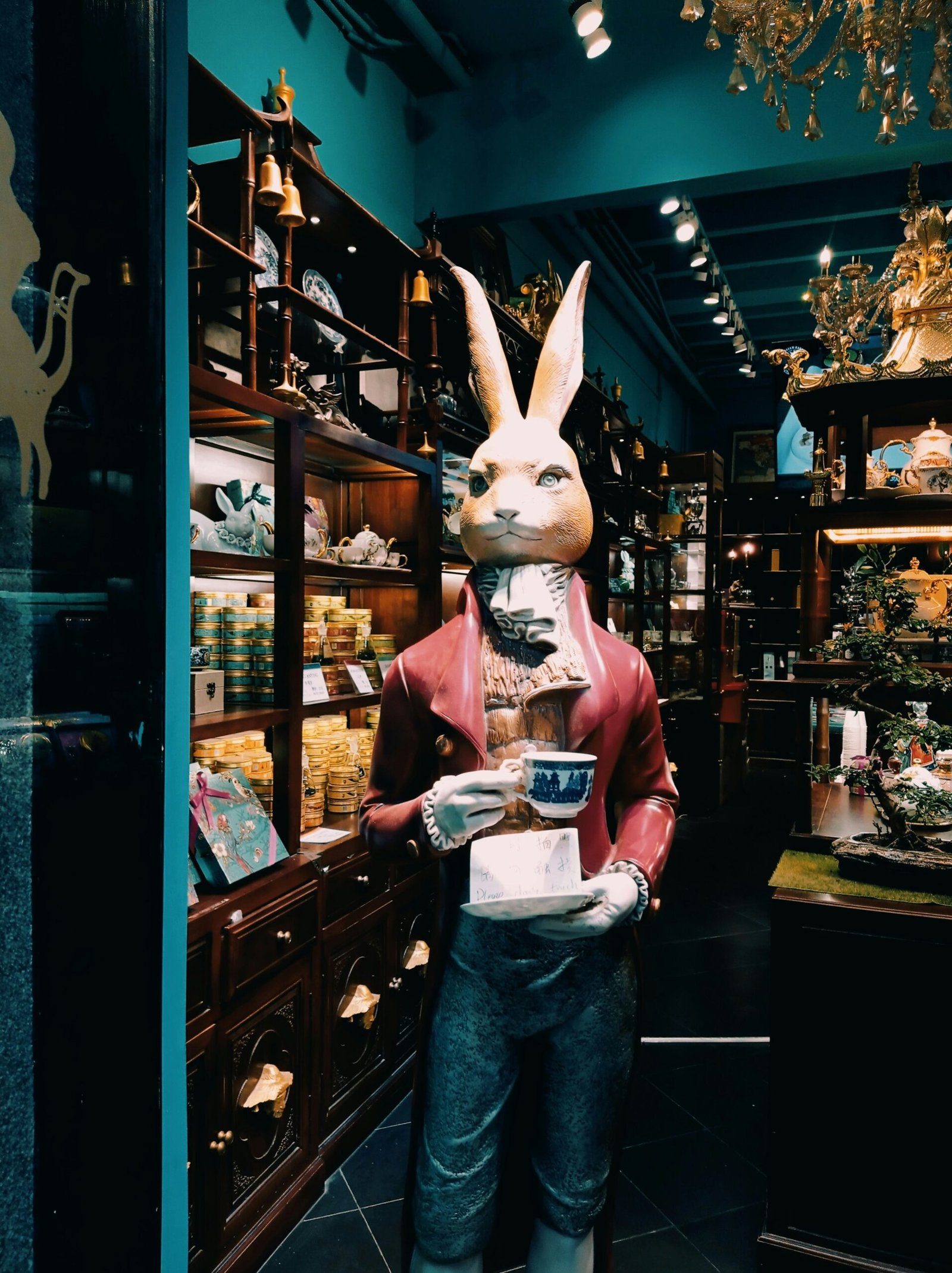 a statue of a rabbit holding a box in a store