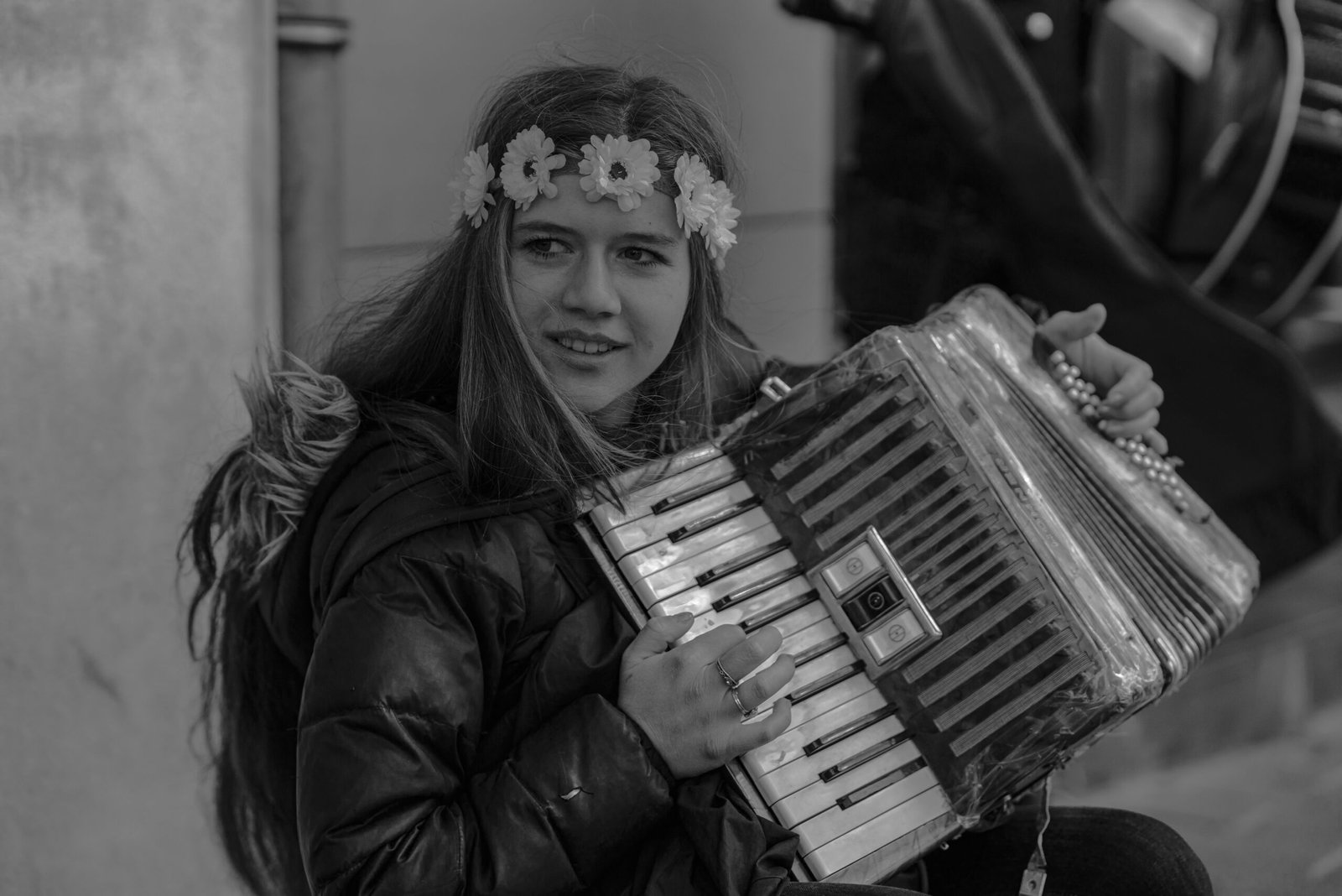 grayscale photo of a woman playing an accordion